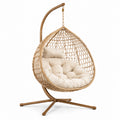 Poltrona sospesa in rattan sintetico con cuscino beige